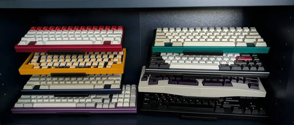 Two colorful keyboard collections on black tiered stands